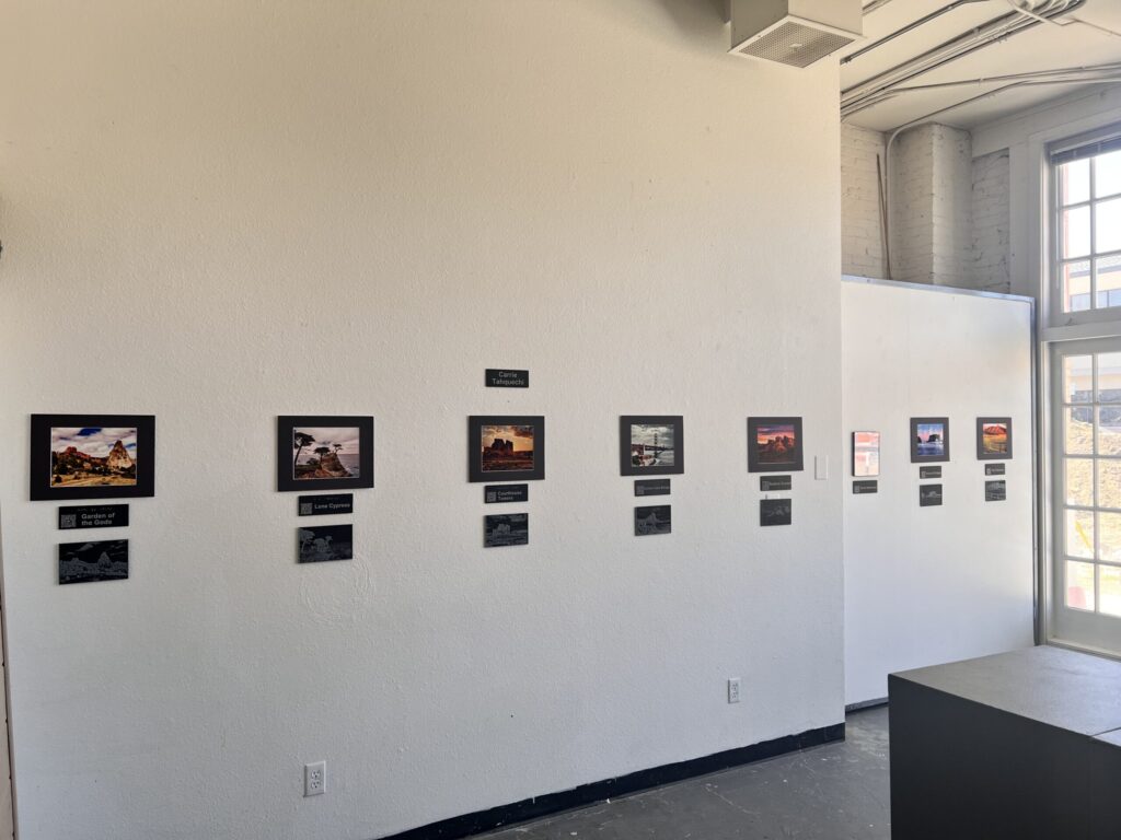 A gallery wall at the Firehouse Art Center with tactile and traditional photos hanging.
