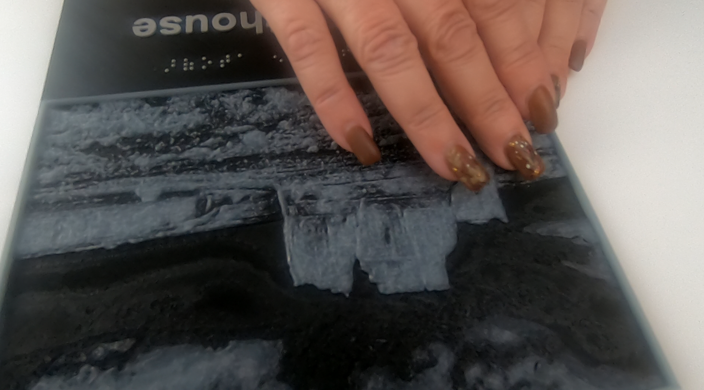 A closeup image of a person toughing a tactile print.